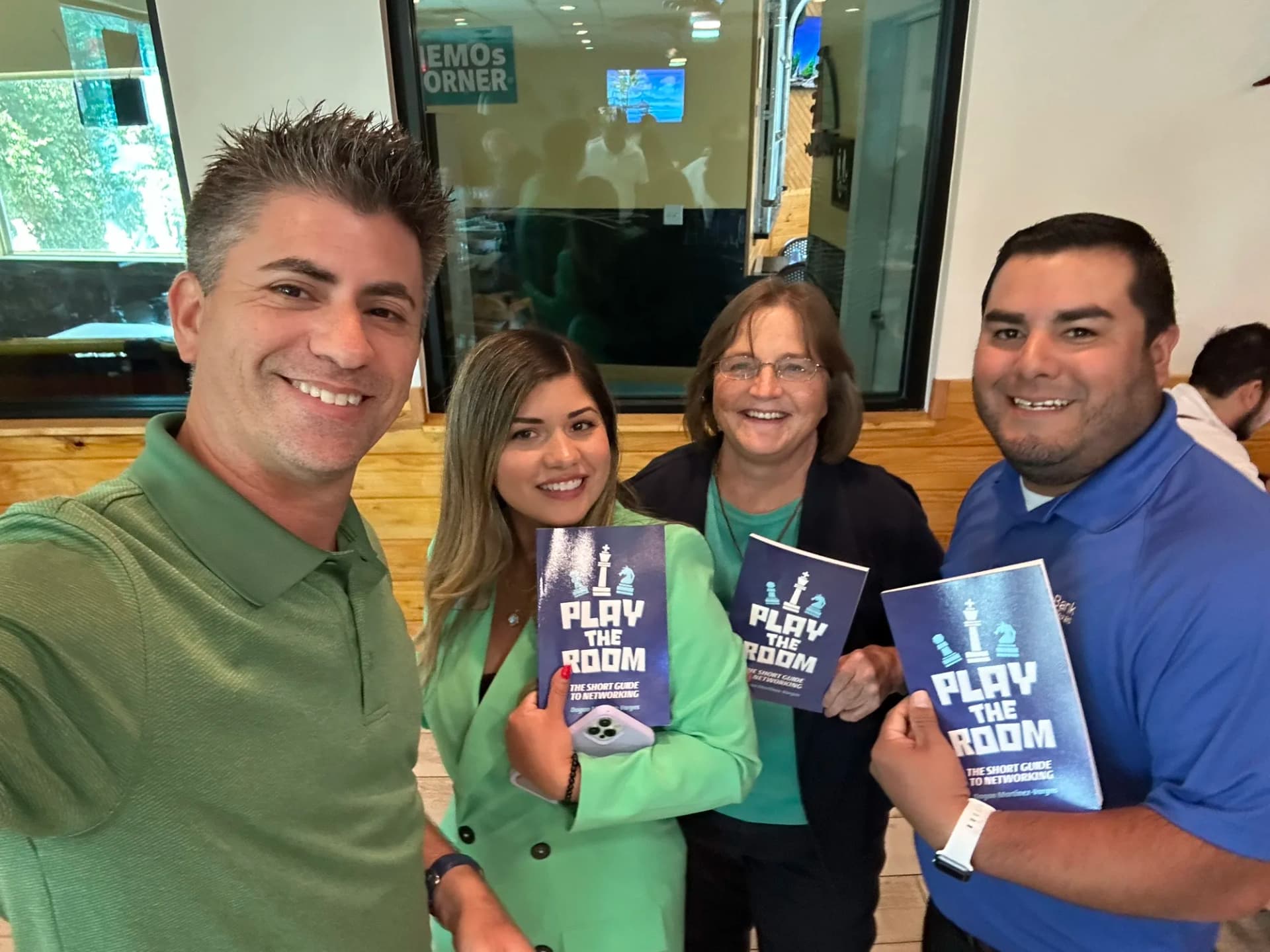 Dagan Martinez-Vargas with a reader holding a copy of Play the Room