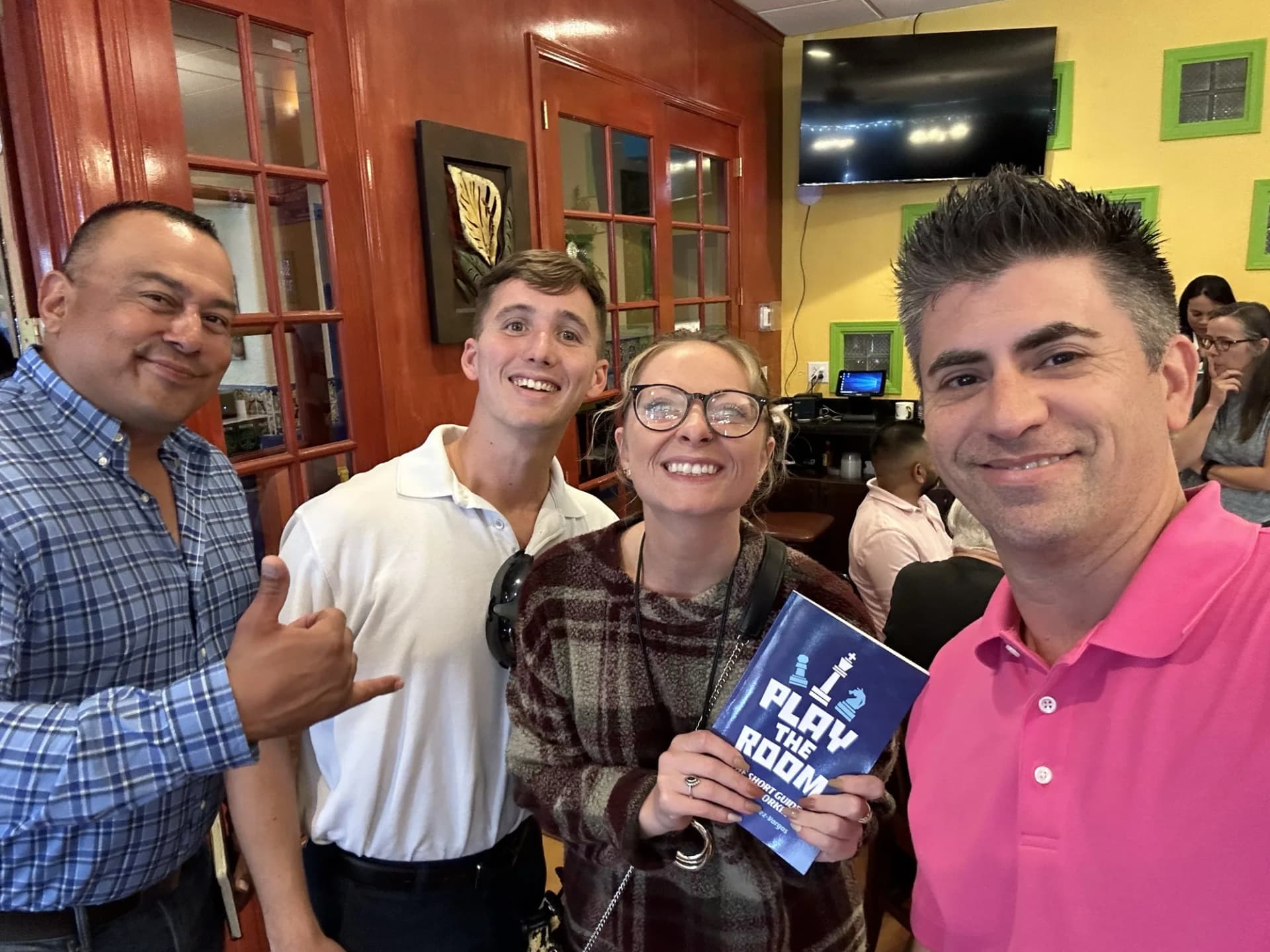 Dagan Martinez-Vargas with a reader holding a copy of Play the Room