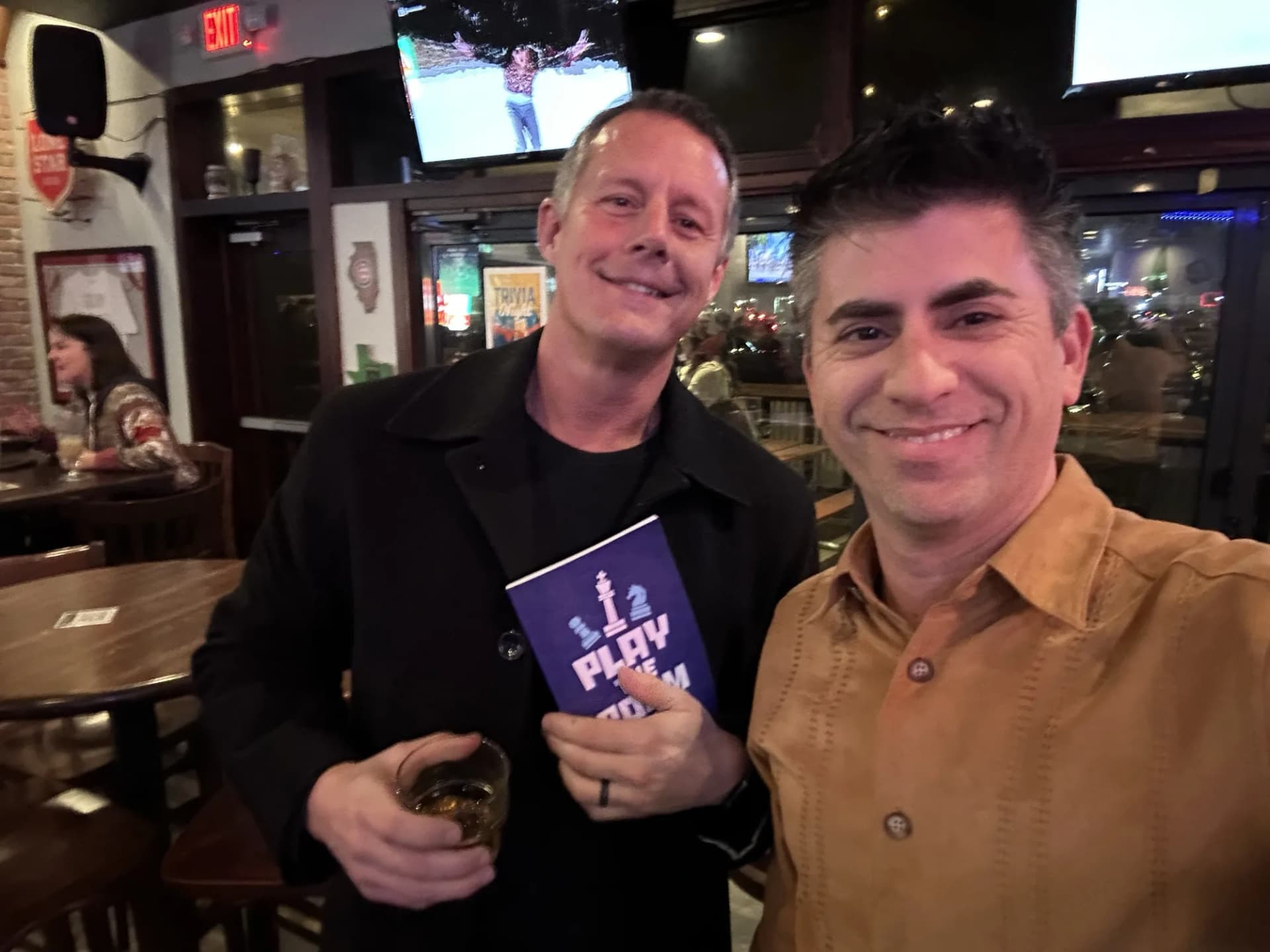 Dagan Martinez-Vargas with a reader holding a copy of Play the Room