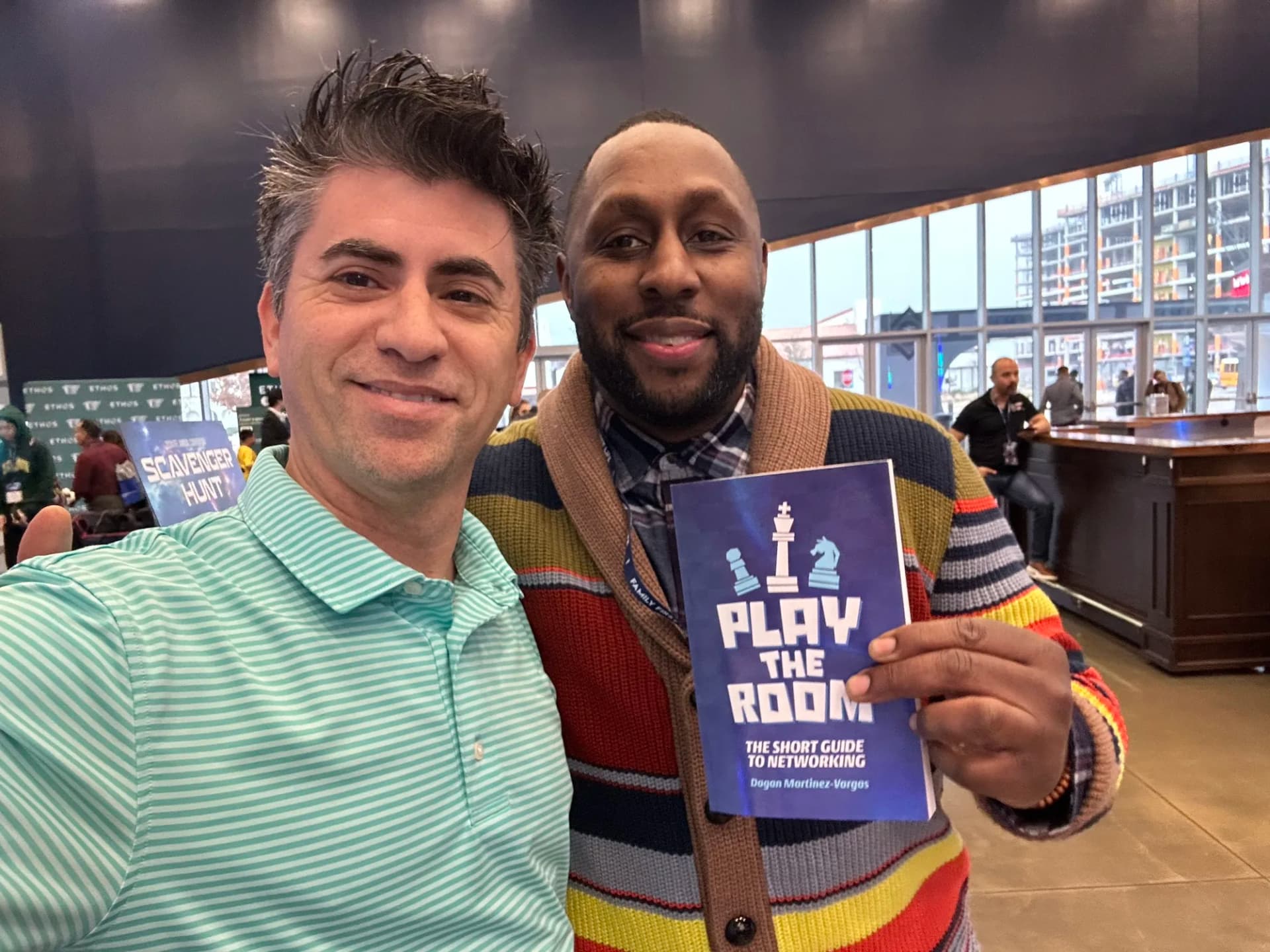 Dagan Martinez-Vargas with a reader holding a copy of Play the Room